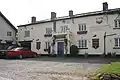 White painted building with pub sign saying The Lamb Inn