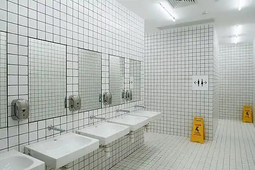 Restroom with white checkered brick walls, a popular spot for photography.