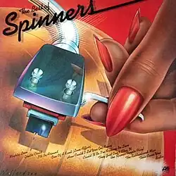 A painting of a hand putting a needle on a golden LP