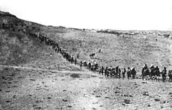 Caravan of people traveling in a line