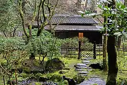 a tea house with a step stone path leading to it