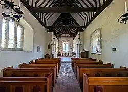 The nave of Alciston Church, Alciston, East Sussex, England. September 2024.