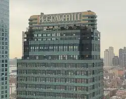 The upper stories of the building. There is a "McGraw-Hill" sign atop the building's crown.