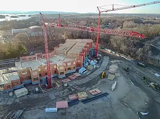Teleoperation tower cranes at a prefabricated framed construction site