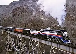 No. 4449 leading an excursion train through the Deschutes River canyon at Trout Creek, Oregon, on March 23, 2002