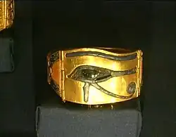 A golden bracelet with the Eye of Horus on it.
