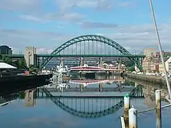 A through arch bridge (Tyne Bridge in Newcastle upon Tyne, England): parabolic-looking arches with multiple deck supports distributing the load