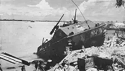 Japanese defenders knocked out this LVT on Beach RED 1, its occupants are dead around it