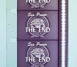 Vertical section of filmstrip, showing four-and-a-half frames, each of which reads, "Sea Power for Security. The End." Alongside the frames runs a continuous vertical white band of continuously fluctuating width.