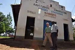 Capt. Jon Cutler, a chaplain and the religious affairs director for Combined Joint Task Force – Horn of Africa, walks with Rabbi Gershom Sizomu at the Moses Synagogue, Abayudaya
