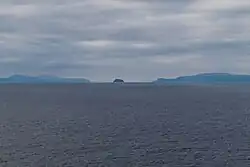 Umnak, Bogoslof and Unalaska Islands as seen from the Bering Sea looking south. Unalaska Island is on the left, Bogoslof Island is in the center, and Umnak Island is on the right.