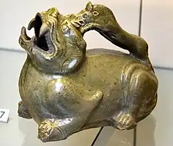Urinal in the form of a tiger. Stoneware with olive green (celadon) glaze. Southern Dynasties, 500–589 CE. From China, Zhejiang. Victoria and Albert Museum