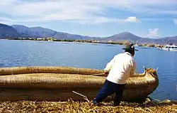 Uro man pulling a boat made of totora reeds