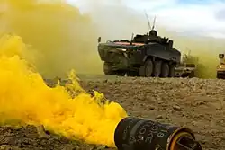Smoke billowing from a yellow M18.