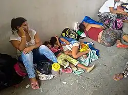 Women and children sleeping on the ground