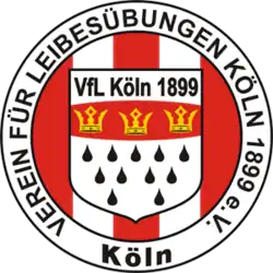 a red and white circular logo, around which is the written the full name of the club, in the centre is a shield which resembles the coat of arms of Cologne with the words "VfL Koln 1899" at the top