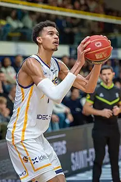 Wembanyama looking up, preparing to shoot a basketball.