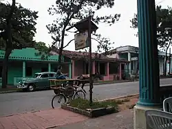 A man rides down the main street in Viñales