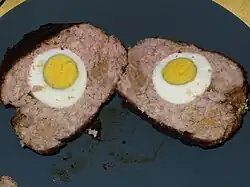Slices of meat with hard-boiled eggs in the middle.