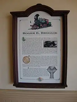 A plaque representing information about a green steam locomotive