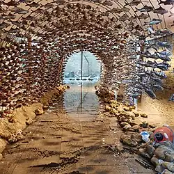 Wave sculpture installation with fish at Norwich Cathedral