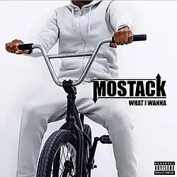 An image of a man wearing a white hoodie and sweatpants on a bicycle.