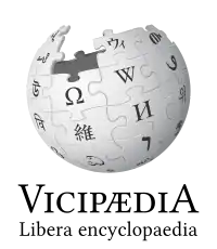 The logo of Latin Wikipedia, an incomplete sphere made of large, white, jigsaw puzzle pieces. Each puzzle piece contains one glyph from a different writing system, with each glyph written in black. The Latin Wikipedia wordmark displays the name Vicipædia, written in all caps. The V and the A are the same height and both are taller than the other letters which are also all the same height.