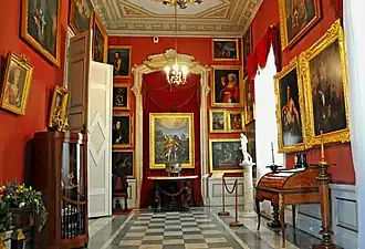 The interior of the palace featuring a gallery of paintings