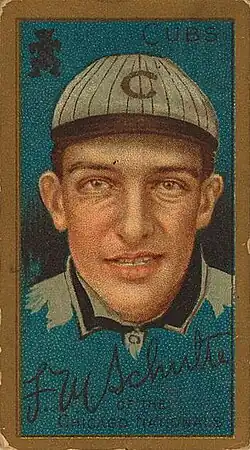 A baseball-card image of a smiling man wearing a crownless white pinstriped baseball cap