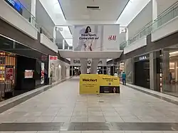 An advertisement for Weichert, Realtors in Wayne, New Jersey's Willowbrook Mall, 2024.