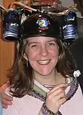 Person wearing beer helmet.