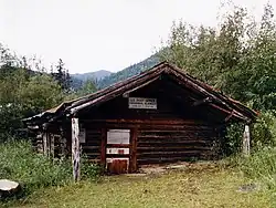 The log-built post office at Wiseman, seen here in 1995, has been sinking into the ground for the past century, and is now a couple of feet below ground.