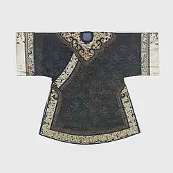 Woman's short coat decorated with a Yunjian appliqué, early 19th century. There is a small round neck opening, and overlap buttoned at neck with two ball buttons and at right side seam with three buttons