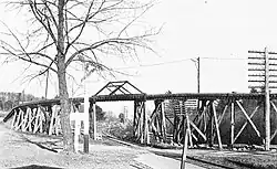 A wooden trestle crossing over a railway line