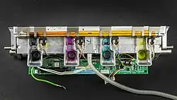 diecast aluminum funnels full of solidified black magenta blue and yellow wax