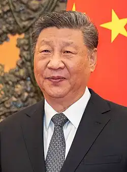 Xi in 2024, wearing black suit, smiling