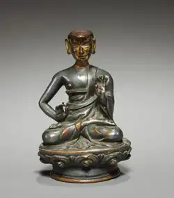 Photo of a statue of a monk sitting in the lotus position